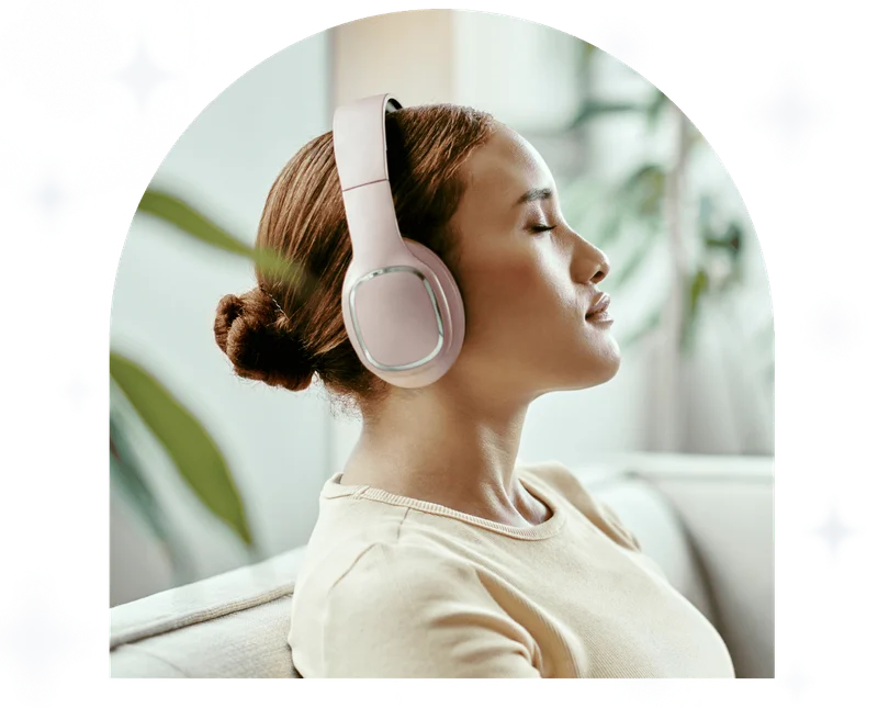 Woman with headphones on couch in living room listen to peaceful meditation