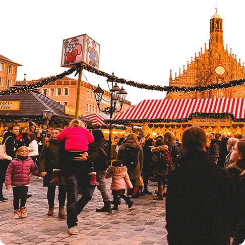 Image Description: A crowd of people at an outdoor holiday market.