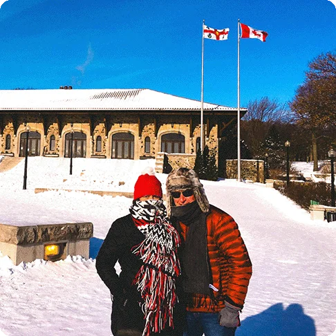 Image Description: Two people posing for a photo in the snow.