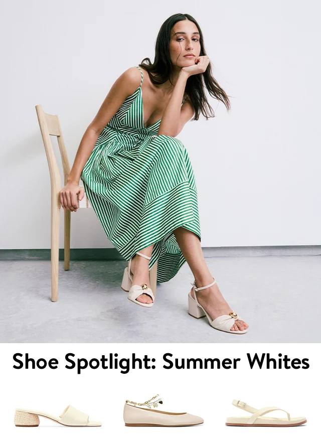 A woman wearing white sandals. White flats, slides and sandals.
