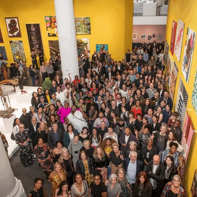 A GIF of people looking at art and smiling