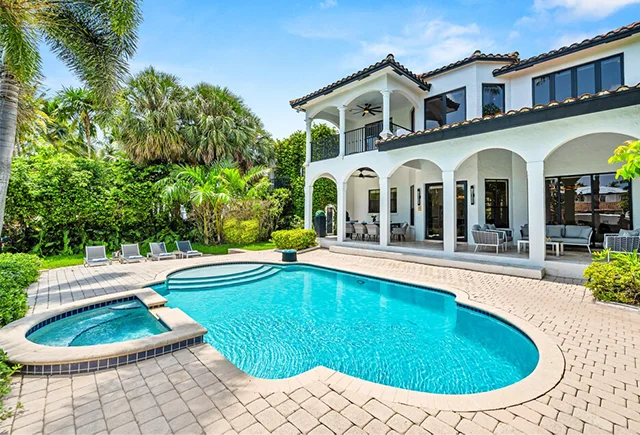 Relax by the pool in a spacious private home rental in Fort Lauderdale, Florida.