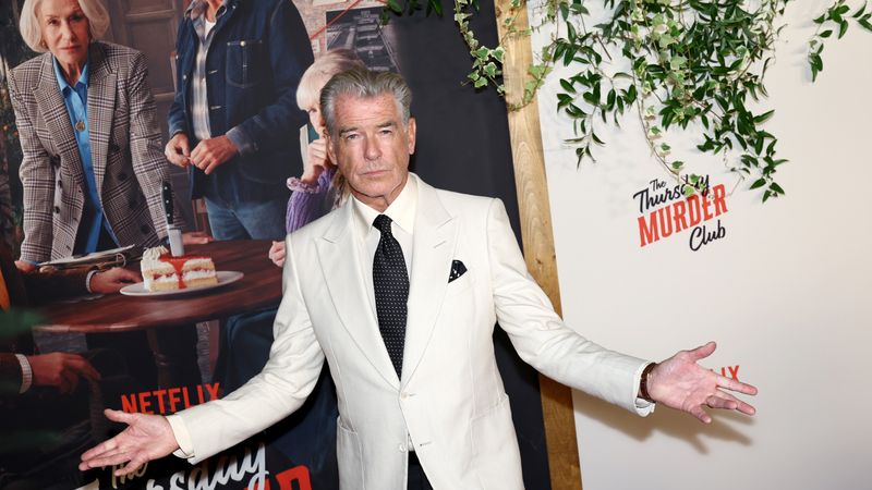Image may contain: Pierce Brosnan, Helen Mirren, Accessories, Formal Wear, Tie, Adult, Person, Fashion, Plate, and Burger
