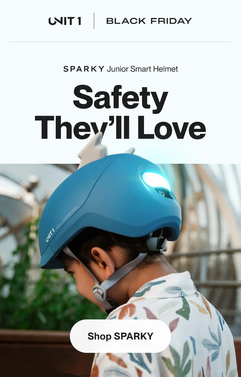 Child wearing a blue SPARKY smart helmet with the rear light on while riding outdoors.