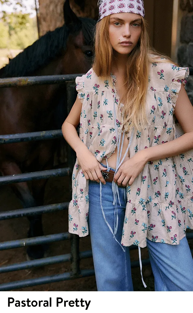 A woman wearing a loose floral-print blouse with jeans. A woman wearing a white eyelet dress.