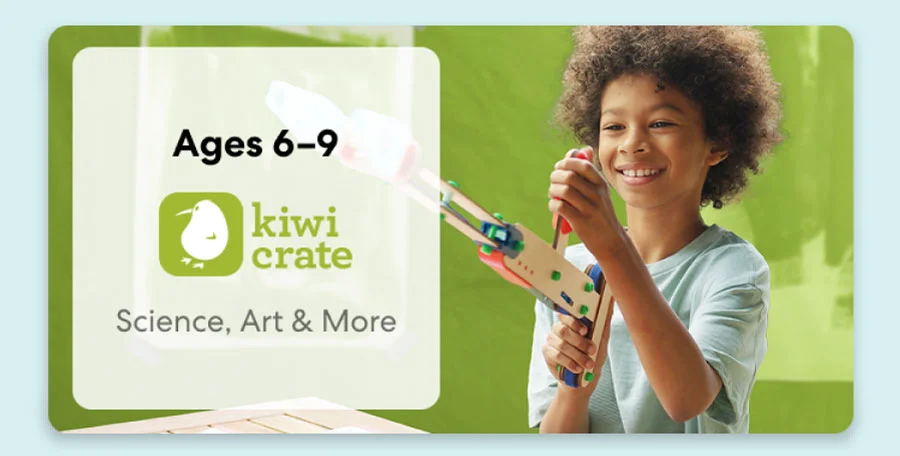 Young girl smiling while working on a science experiment from KiwiCo Labs. Hands-on STEM learning for ages 6–8.