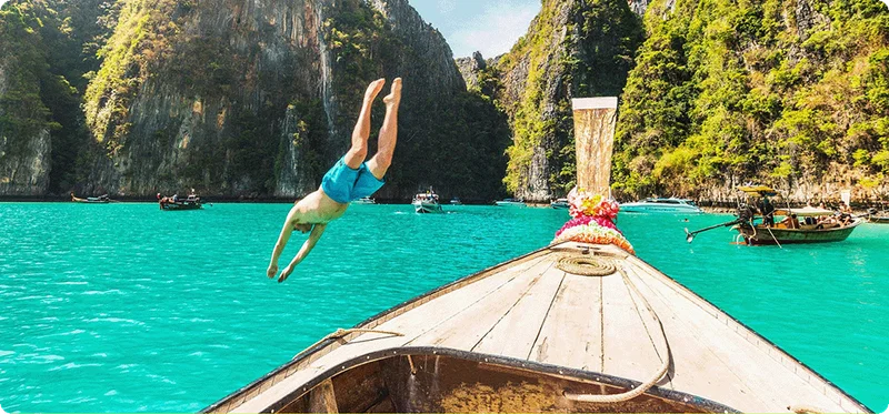 Image Description: A person diving off a boat into the water.