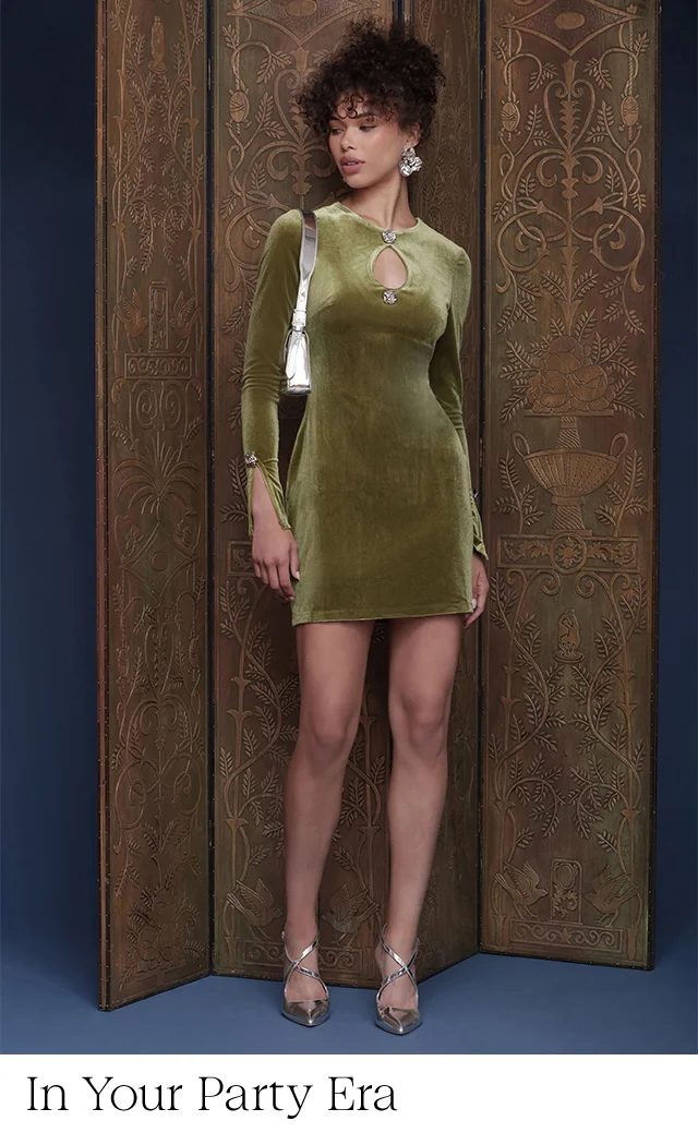 A woman wearing a green velvet minidress.