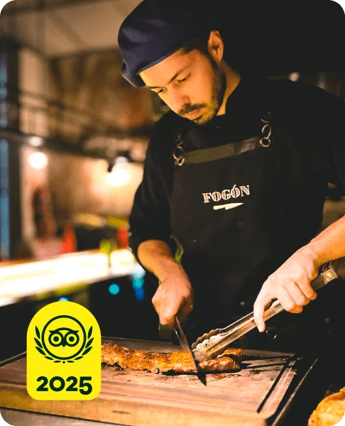 Image Description: A chef cutting food on a cutting board. A yellow 2025 Travelers’ Choice Awards Best of the Best badge is on the bottom left corner of the image.