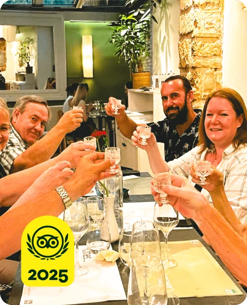 Image Description: People at a table toasting with drinks. A yellow 2025 Travelers’ Choice Awards Best of the Best badge is on the bottom left corner of the image.
