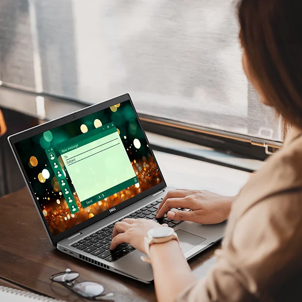 Woman working on a Latitude 15 5000 Series (Model 5550) Notebook on a Digital Work Technology Environment