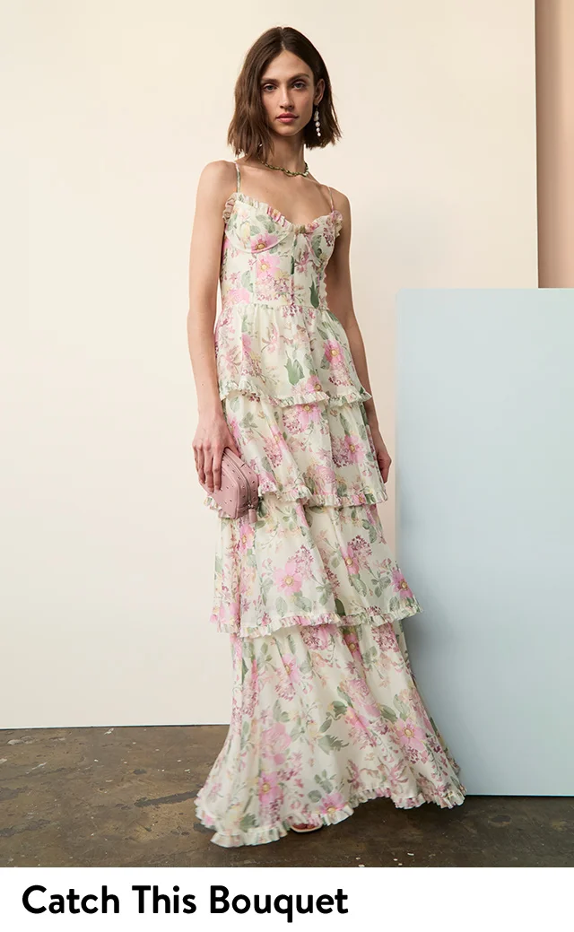A woman wearing a tiered floral maxi dress.