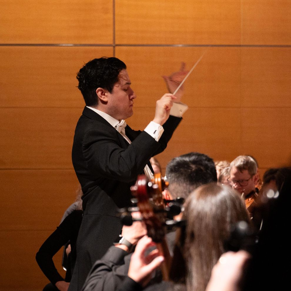 A conductor leading an orchestra