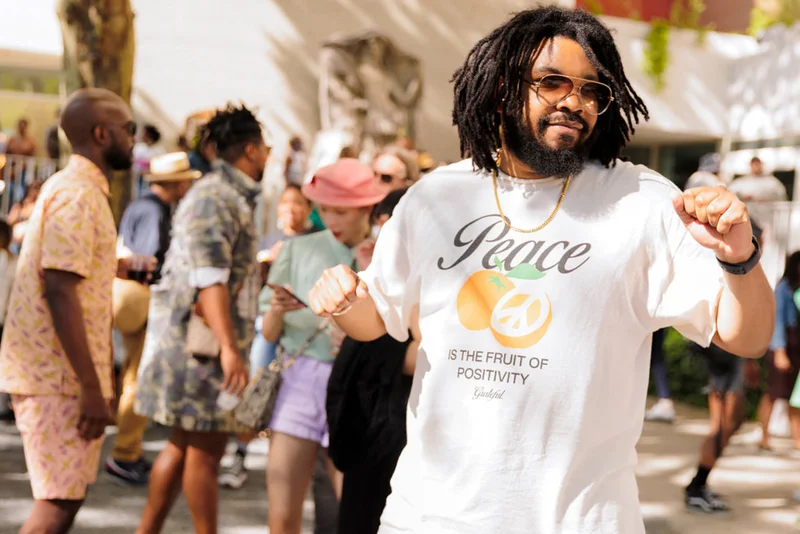 A man smiling and dancing outside