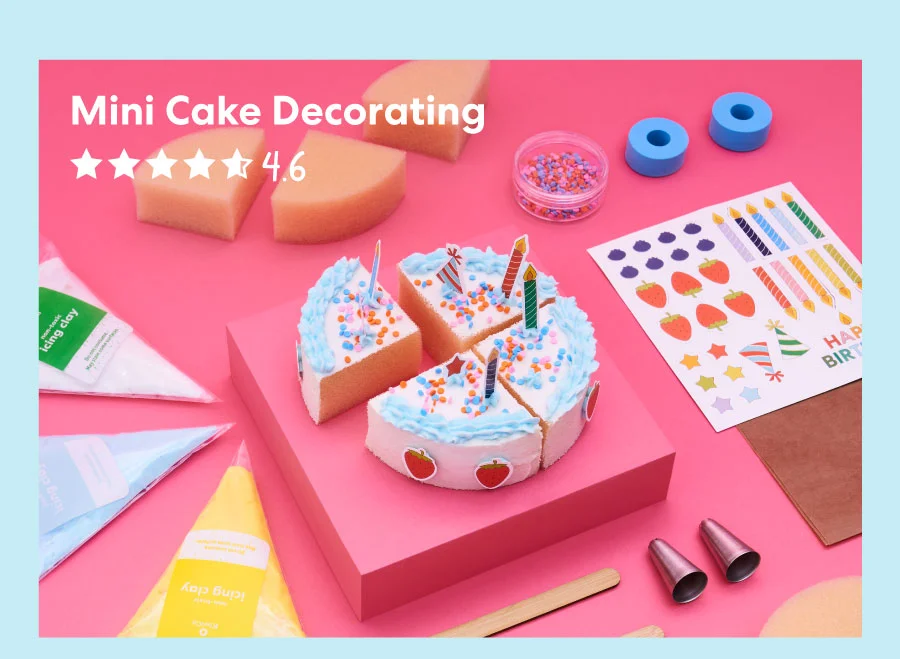 A pastel pink background displays a baking-themed craft kit with a colorful instruction booklet, small cakes decorated with frosting and sprinkles, piping bags, and decorating tools. The text overlay reads, ''Mini Cake Decorating'' with a 4.6-star rating.