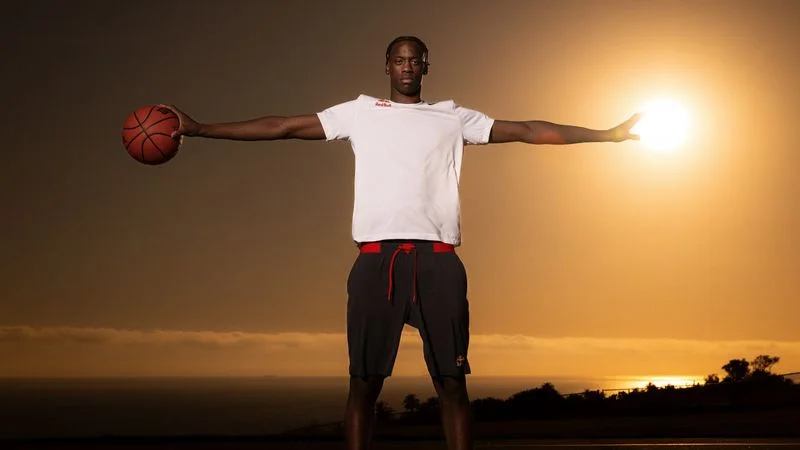 AJ Dybantsa posing with a basketball in front of a sunset AJ Dybantsa posing with a basketball in front of a sunset
