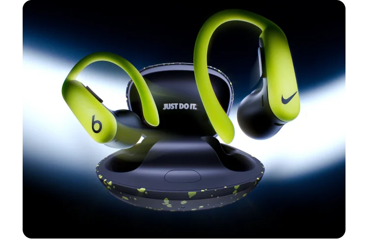 A pair of special-edition Nike Powerbeats Pro 2 earbuds and charging case floating against a dark background.