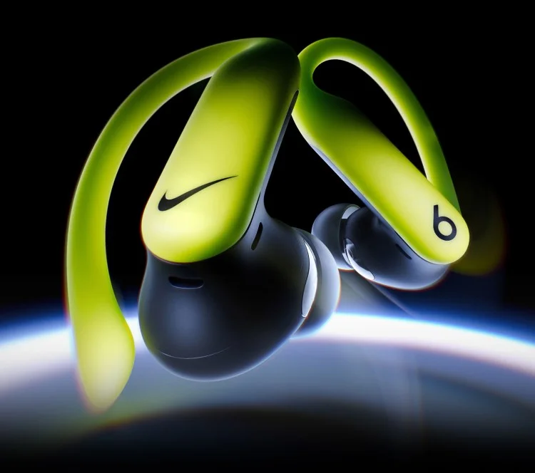 A pair of special-edition Nike Powerbeats Pro 2 earbuds floating against a dark background.