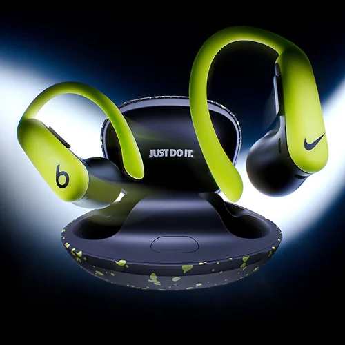 A pair of special-edition Nike Powerbeats Pro 2 earbuds and charging case floating against a dark background.