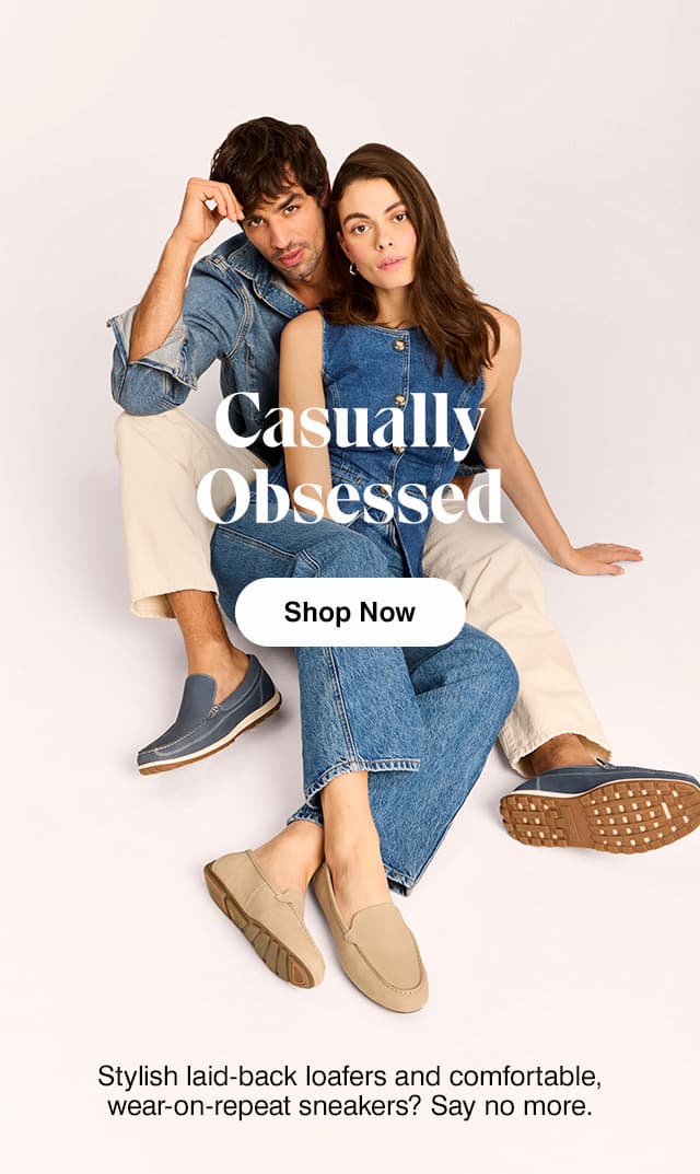 Man wearing a denim button-up, off-white jeans and the Emmet loafer in Navy with a woman in a denim vest, jeans and the Ozzie loafer in Khaki wide-width.