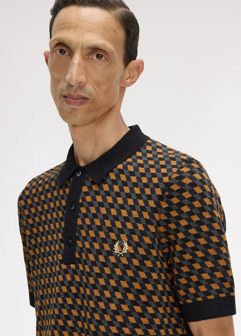 A male model wearing a Fred Perry Geometric Knitted Shirt in Dark Caramel