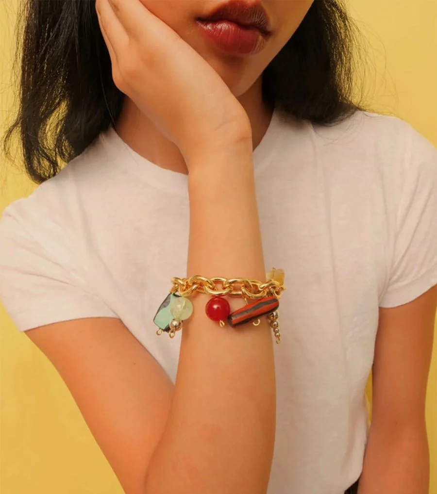 Woman wearing chunky charm bracelet