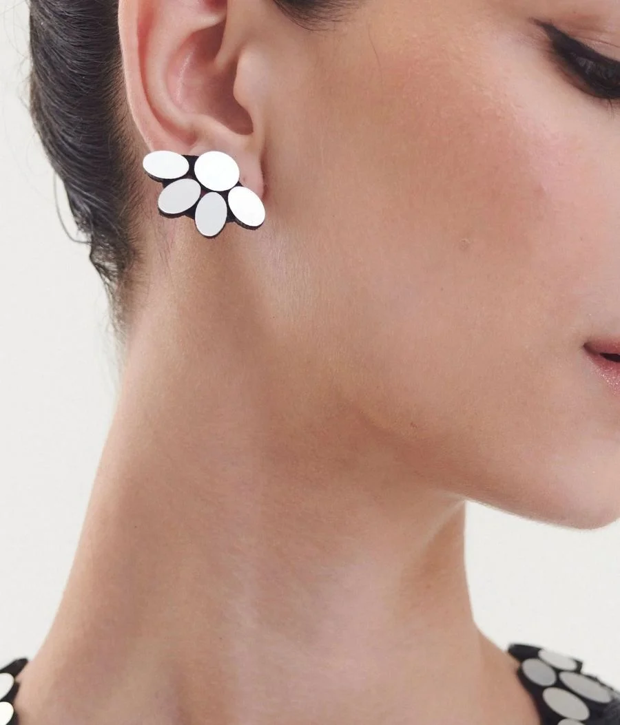 Woman wearing chunky silver earrings