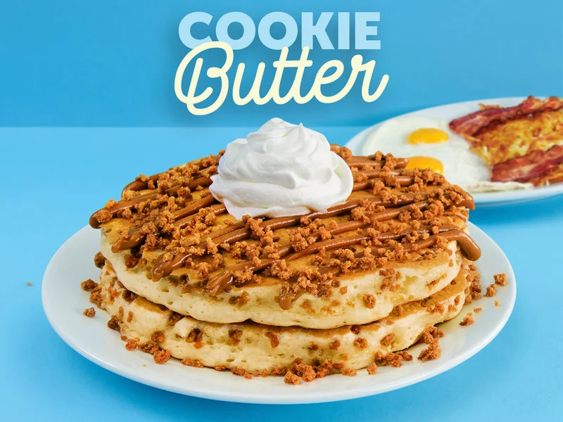 Two Cookie Butter Pancakes, filled with cookie pieces and topped with Biscoff Cookie Butter, whipped topping, and cookie crumbles