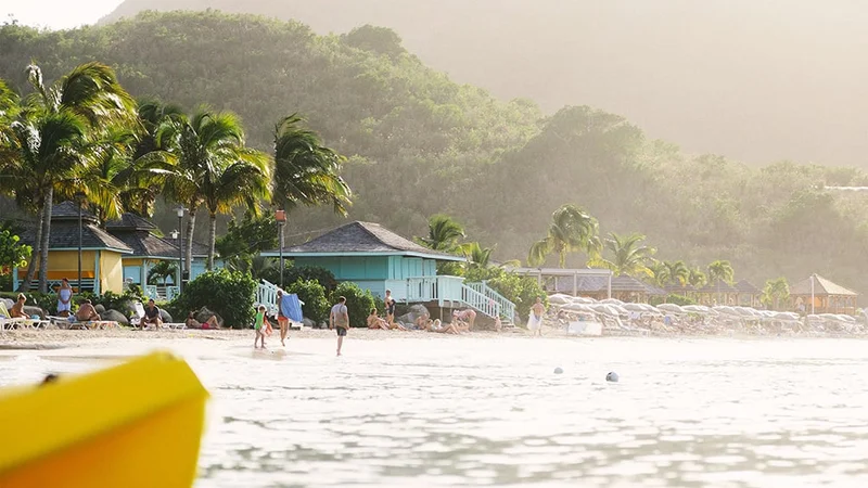 Image description: Tourists walking on beach on Saint Martin