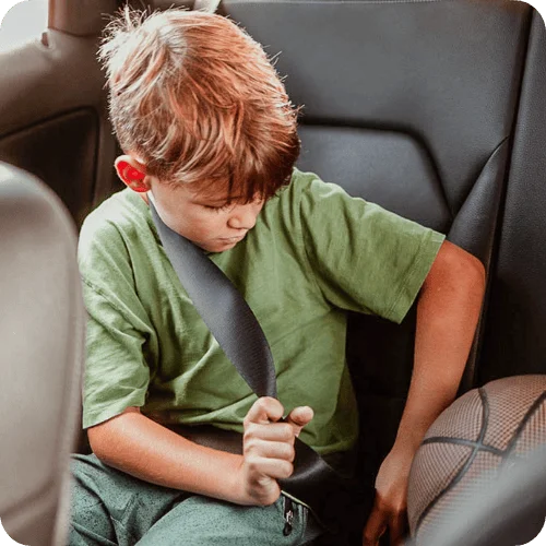 boy buckling seat belt at school pickup boy buckling seat belt at school pickup