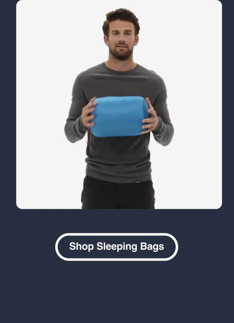 A person holding a sleeping bag. Shop Sleeping Bags