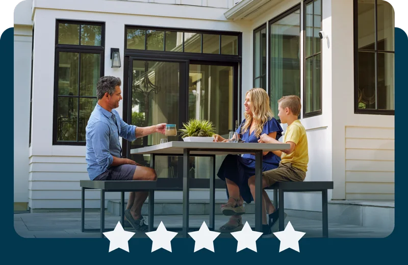 5 stars. Family sitting outside at a table with Arlo security products mounted nearby.