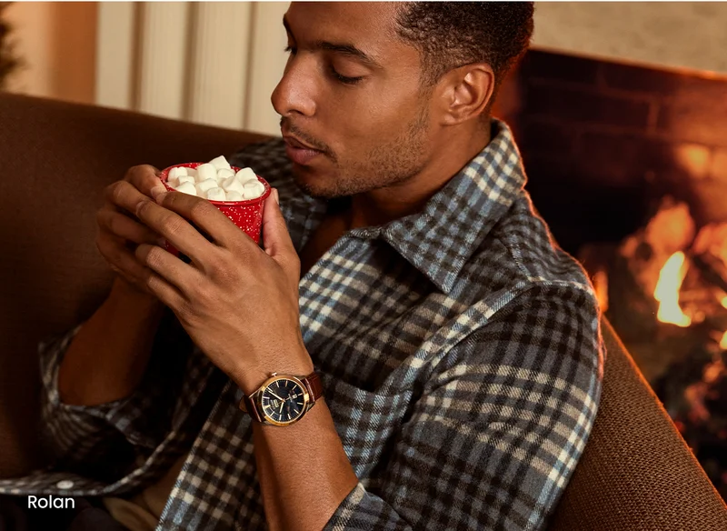 Person wearing the Rolan and having hot chocolate with marshmellows