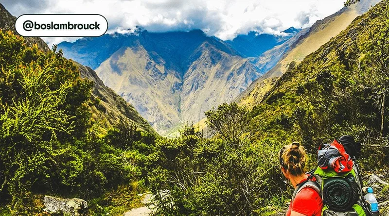 Image description: A hiker looking out at mountains and a valley on the Inca Trail, photo taken by @boslambrouck