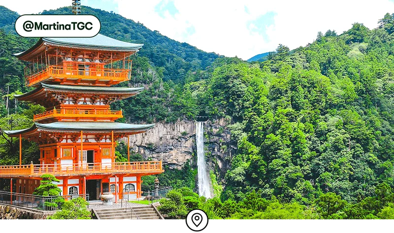 Image description: The vibrantly red Kumano Nachi Taisha shrine with a waterfall behind, photo taken by @MartinaTGC