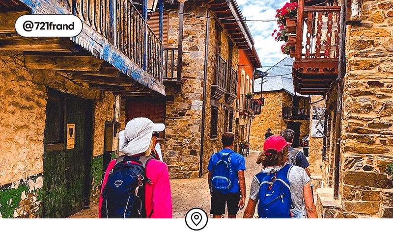 Image description: A group of adults with backpacks walking between stone buildings, photo taken by @721frand