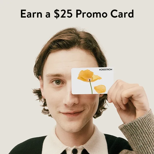 Earn a $25 promo card. Man holding a Nordstrom gift card.