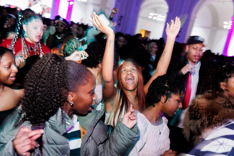 People standing together cheering and dancing