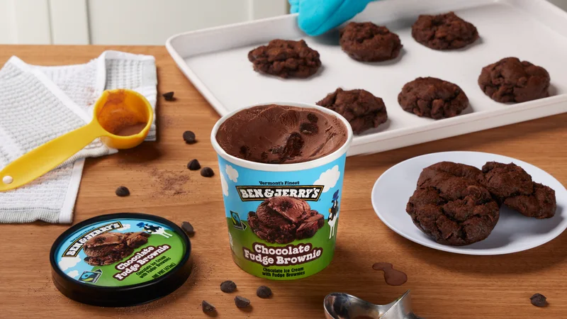 Pint of Ben & Jerry's Chocolate Fudge Brownie ice cream next to a pan of chooclate cookies.