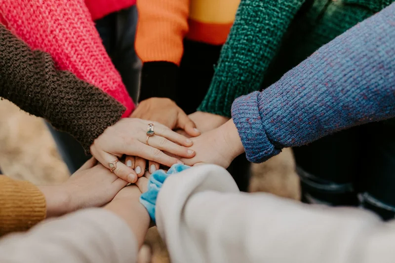 Hands piled on top of each other.