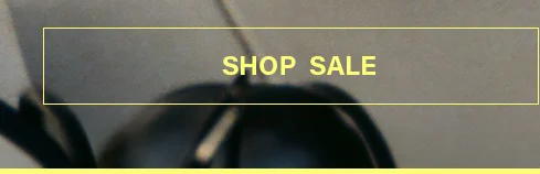 Yellow 'SHOP SALE' text within a border on a blurry dark background, prompting users to explore current discounts and special offers.