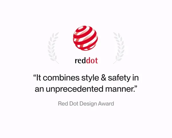 Red Dot Design Award logo with text: 'It combines style & safety in an unprecedented manner,' showcasing the helmet's design recognition.