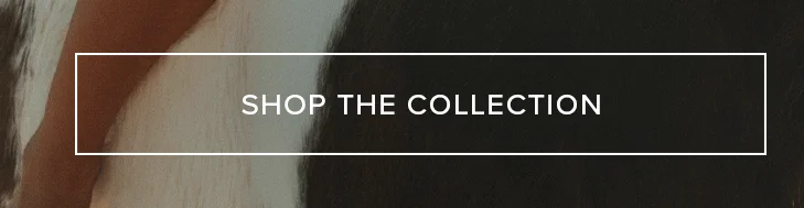 SHOP THE COLLECTION button over a soft, light brown textile and dark, textured background. Explore our new collection and discover unique styles.