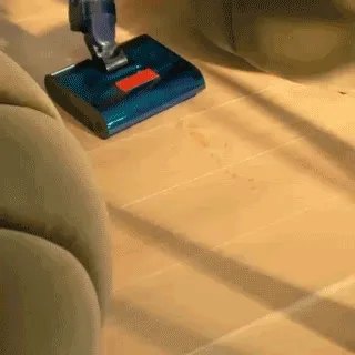 Dyson Clean+Wash Hygiene wet cleaner washing the floor, in between chairs.