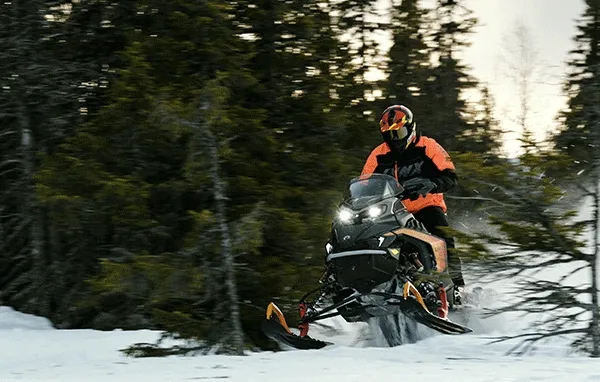 Rider on snow with Lynx sled