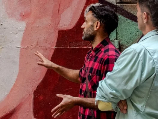 two people viewing a mural