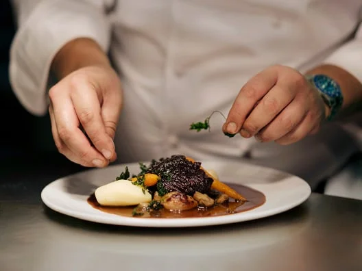 a chef plating food