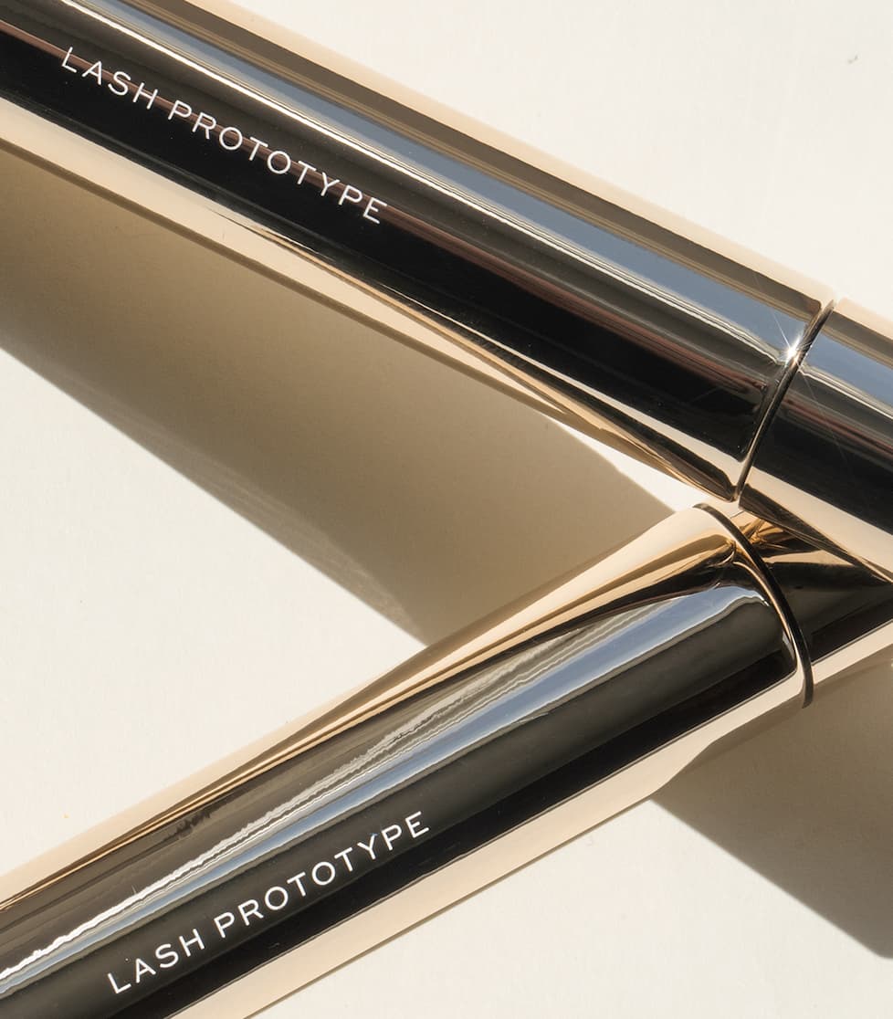 an image of a close up of a mascara and a mascara brush
