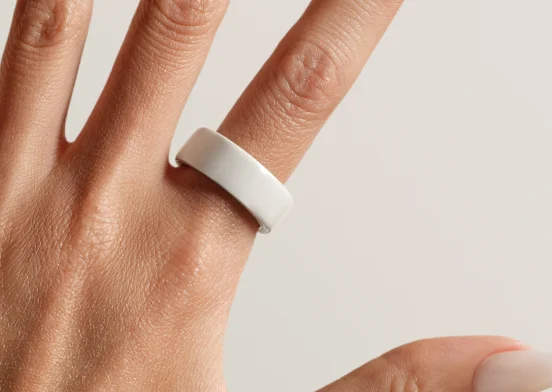 Hands wearing Oura Ring 4 Ceramic Cloud