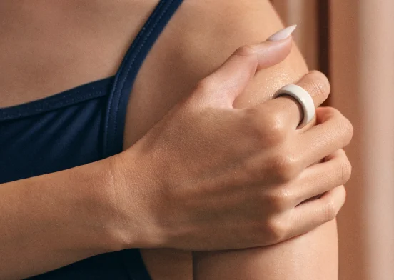 Hands wearing Oura Ring 4 Ceramic Cloud